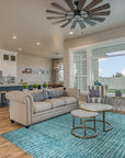 Lush Moroccan Green Hand Knotted Wool Rug gracing a bright, modern living room; intricate geometric patterns rendered in rich shades of green and cream create a focal point anchoring a seating area with a mid-century modern sofa.