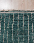 Lush Moroccan Green Hand Knotted Wool Rug, its plush pile a verdant expanse, anchoring a bright living room with natural light and crisp white walls.