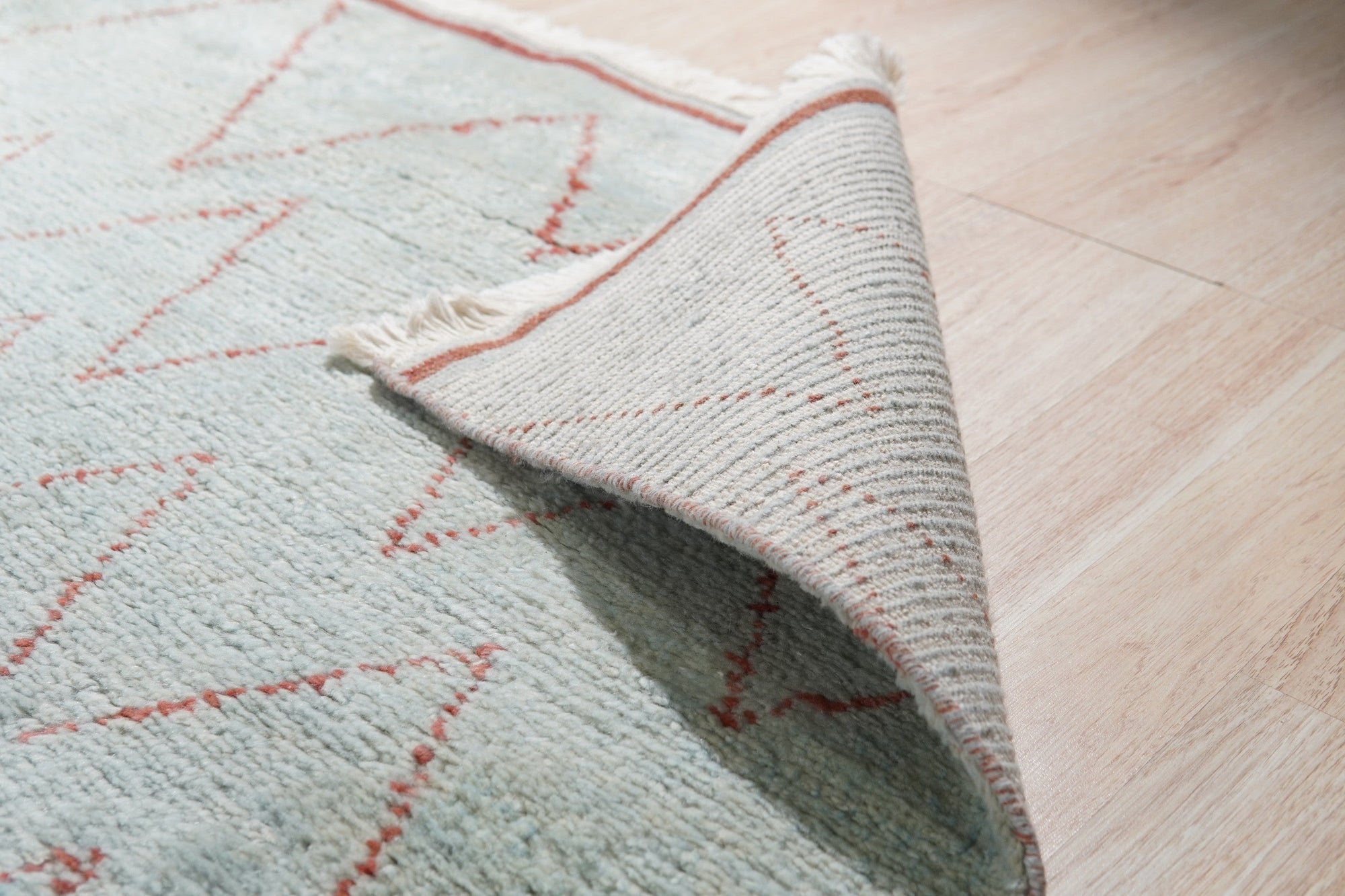 Isla Moroccan Light Blue Hand Knotted Wool Rug, its subtle light blue hues and intricate Moroccan-inspired patterns softening a contemporary living space.