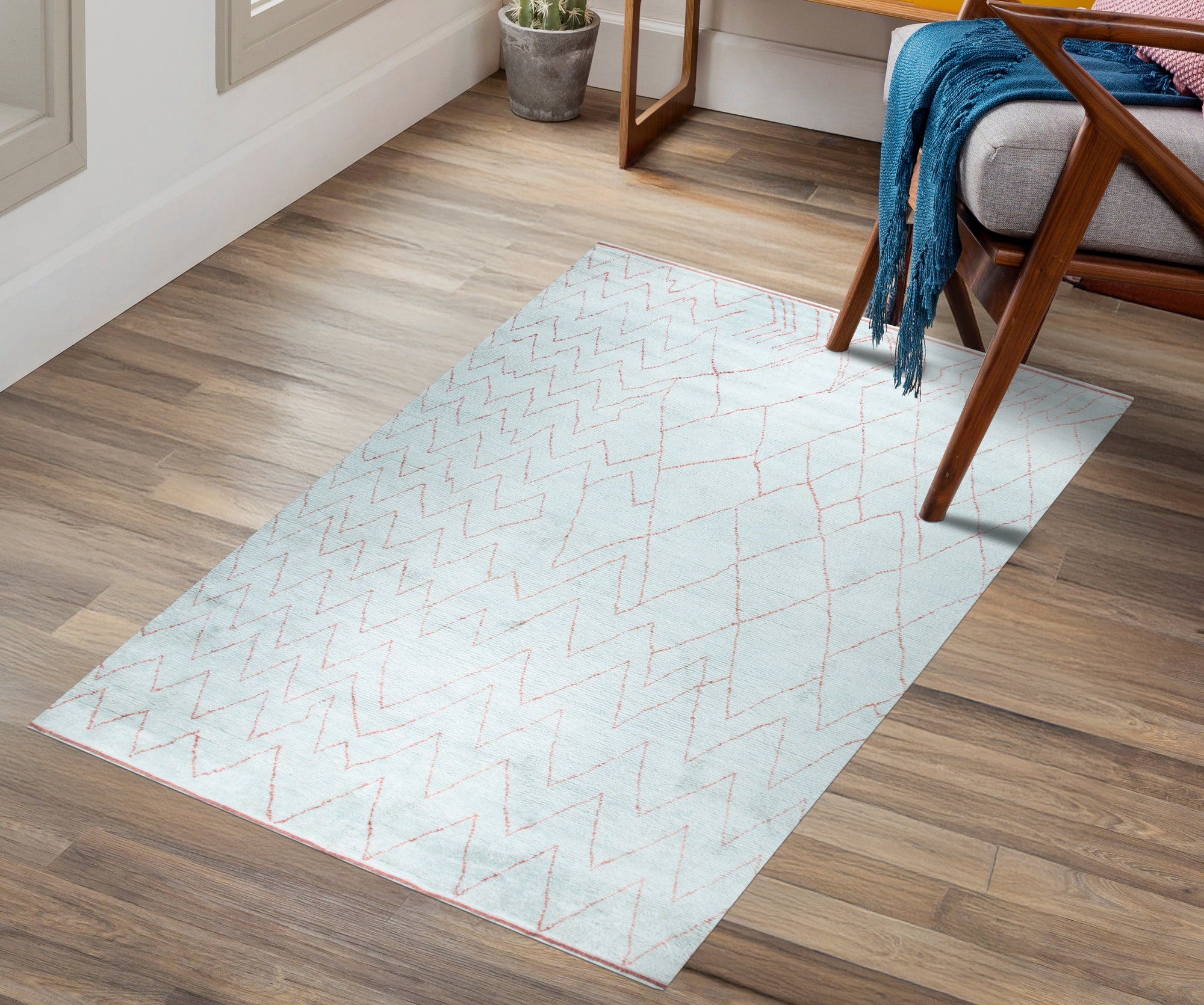 Isla Moroccan Light Blue Hand Knotted Wool Rug, its soft light blue tones and intricate hand-knotted wool texture adding warmth and subtle pattern to a bright, modern living space.