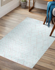 Isla Moroccan Light Blue Hand Knotted Wool Rug, its soft light blue tones and intricate hand-knotted wool texture adding warmth and subtle pattern to a bright, modern living space.