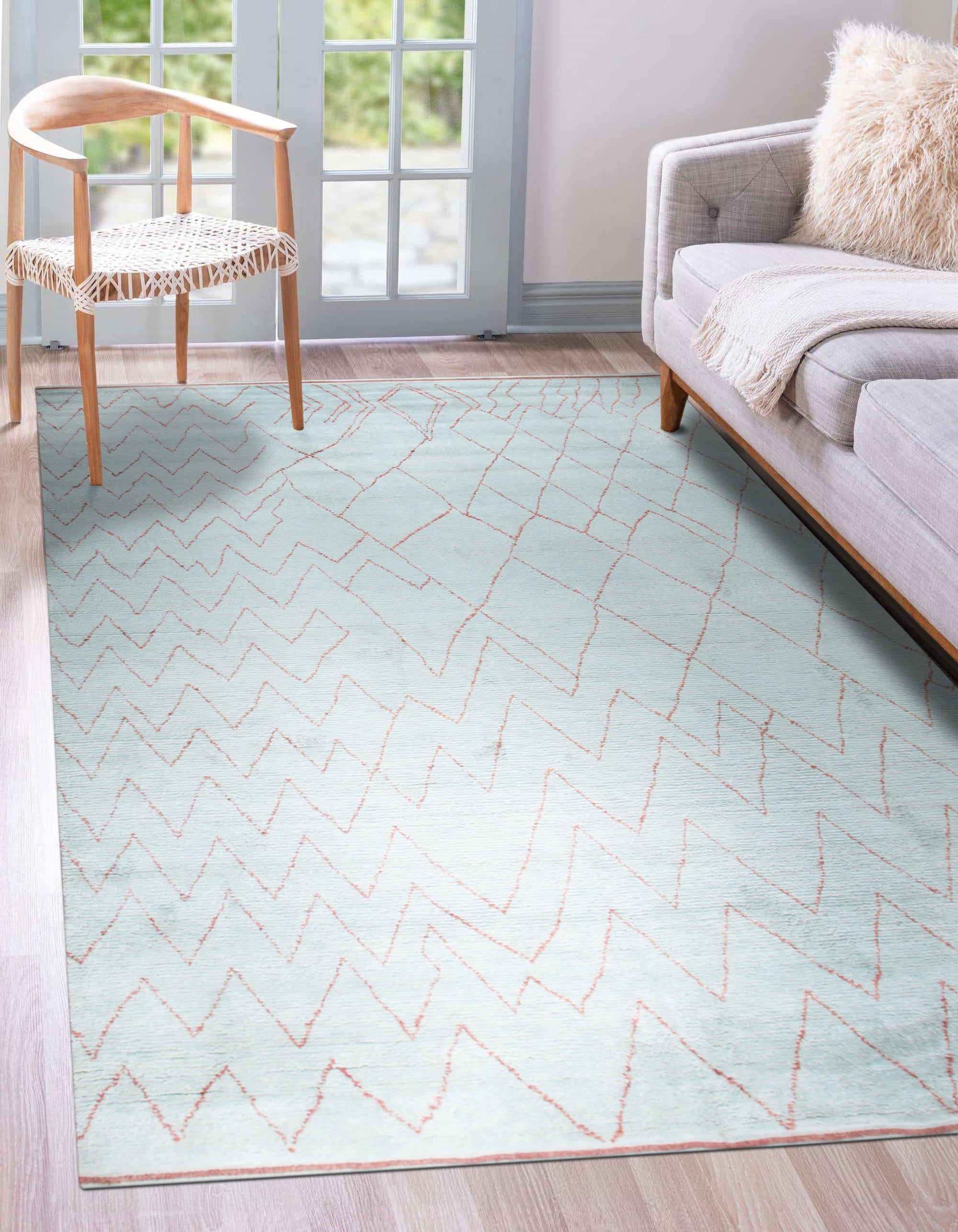 Isla Moroccan Light Blue Hand Knotted Wool Rug, showcasing a bright and airy living space where the rug's light blue tones complement the natural light and neutral decor.