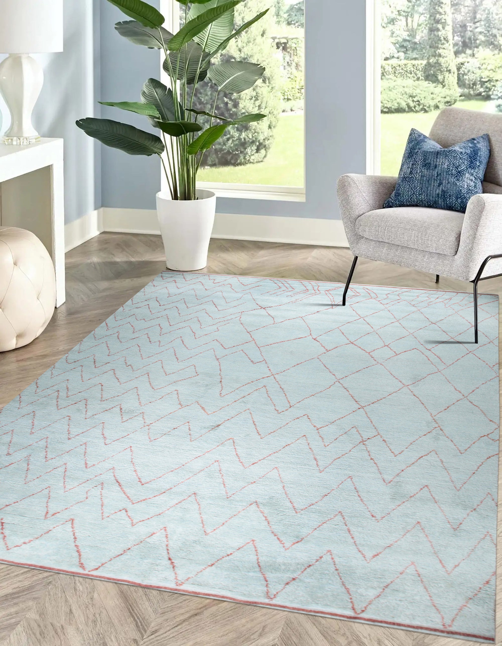Isla Moroccan Light Blue Hand Knotted Wool Rug graces a warmly lit interior; its soft light blue tones and hand-knotted wool texture complement the neutral backdrop, creating a calming and inviting space.