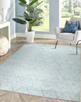 Isla Moroccan Light Blue Hand Knotted Wool Rug graces a warmly lit interior; its soft light blue tones and hand-knotted wool texture complement the neutral backdrop, creating a calming and inviting space.