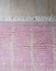 Delicate Moroccan Pink Hand Knotted Wool Rug, a blush-toned wool rug featuring traditional Moroccan motifs, displayed to showcase its texture and craftsmanship.