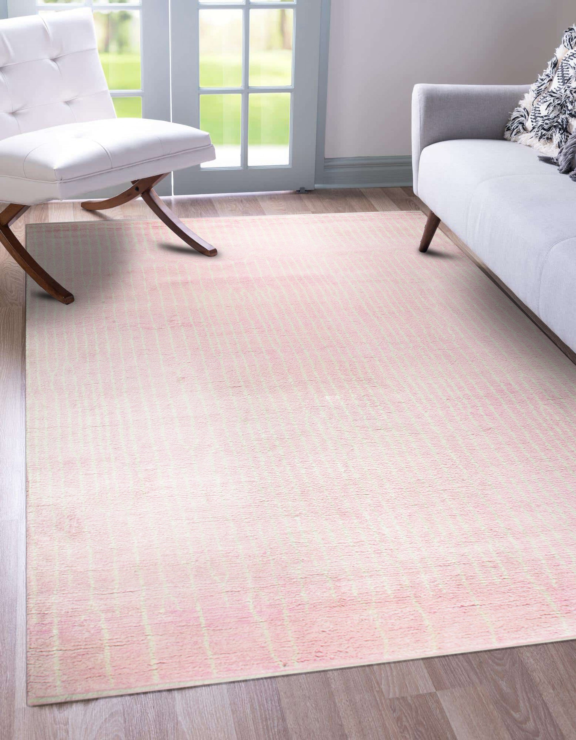 Delicate Moroccan Pink Hand Knotted Wool Rug, its subtle blush tones and intricate geometric patterns lending warmth to a bright, modern living space.