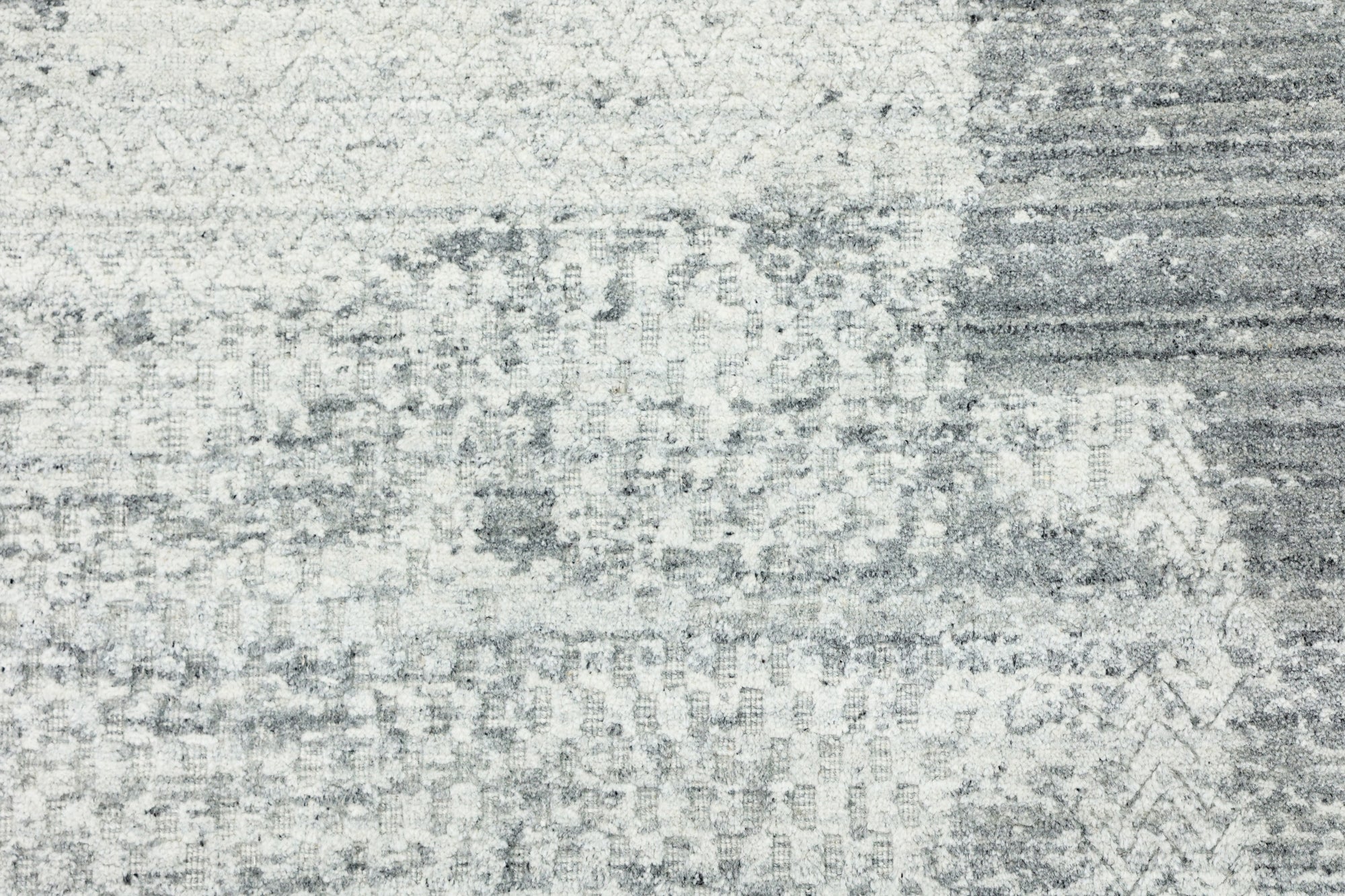 Versatile Freya Gray Handmade Wool Rug displayed on a light wood floor, its subtle gray tones and textured weave adding warmth to a modern living space.