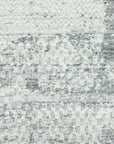 Versatile Freya Gray Handmade Wool Rug displayed on a light wood floor, its subtle gray tones and textured weave adding warmth to a modern living space.