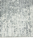 Versatile Freya Gray Handmade Wool Rug, showcasing its subtle, textured gray wool construction and elegant, minimalist design in a softly lit room setting.