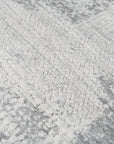 Versatile Freya Gray Handmade Wool Rug, a gray wool rug with a subtle geometric pattern, displayed in a bright, modern living room setting, softening the space with texture and muted tones.