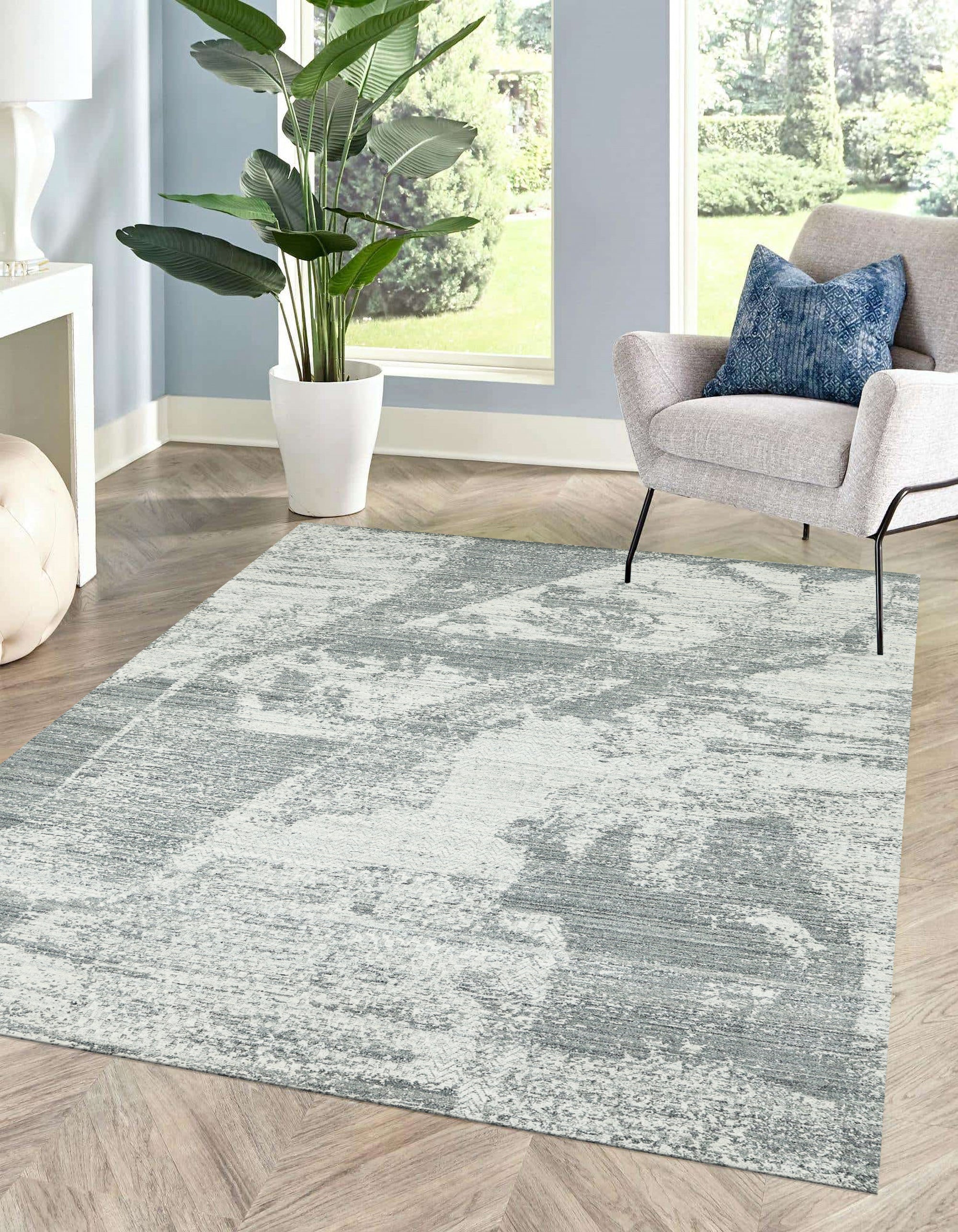 Versatile Freya Gray Handmade Wool Rug, showcasing its textural depth and subtle variations in gray tones, laid on a light wood floor to highlight its versatility and cozy appeal.