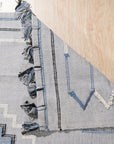 Rustic Penelope Silver Flatweave Rug anchoring a living space, its flatweave construction and silver hues complementing modern furniture and warm lighting.