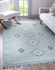 Rustic Penelope Silver Flatweave Rug graces a cozy living space, its flatweave construction lending a casual elegance. Soft silver tones blend seamlessly with a subtly textured design, anchoring the room with understated warmth.