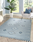 Rustic Penelope Silver Flatweave Rug, showing a close-up texture of woven fibers in shades of silver and grey, demonstrating the flatweave construction and rustic design.