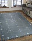 Sleek Inviting Gray Flatweave Rug, a calming gray rug with subtle texture, grounding a modern living space with natural light and minimalist furniture.