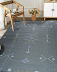 Sleek Inviting Gray Flatweave Rug layered over a lighter hardwood floor, its subtle gray tones and flatweave construction adding depth and texture to a minimalist interior.