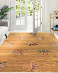 Isla Willow Brown Hand Knotted Wool Rug, its muted browns and subtle willow pattern lending warmth to a sunlit living space with mid-century modern furniture.