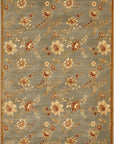Isolated view of Amara Elegant Blue Machine Made Wool Rug, showcasing its intricate, swirling floral design in varying shades of blue against a lighter, possibly cream or beige, background.