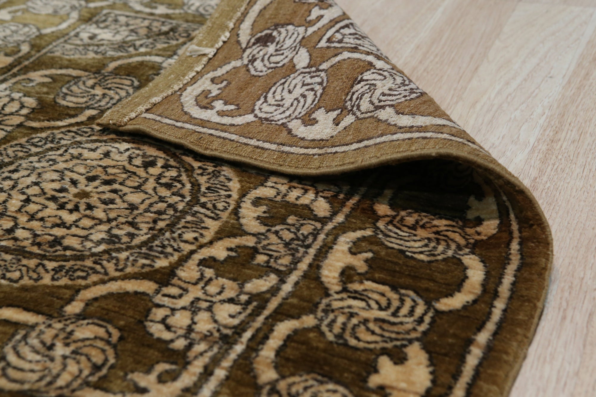 Tessa Ella Brown Hand Knotted Afghan Wool Rug, showcasing a warm brown palette and intricate, geometric design in a living room setting. Soft, hand-knotted texture visible, adding depth and comfort to the space.