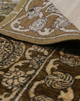 Tessa Ella Brown Hand Knotted Afghan Wool Rug, showcasing a warm brown palette and intricate, geometric design in a living room setting. Soft, hand-knotted texture visible, adding depth and comfort to the space.