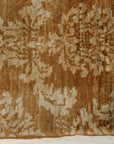 Rustic Bespoke Brown Hand Knotted Afghan Wool Rug, its warm brown tones and hand-knotted texture complement a light hardwood floor, creating a cozy and inviting space.