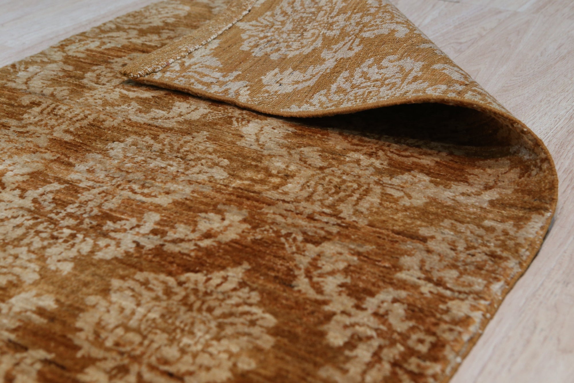 Rustic Bespoke Brown Hand Knotted Afghan Wool Rug, its warm brown hues and intricate hand-knotted patterns lending a touch of rustic elegance to a comfortably furnished living space.