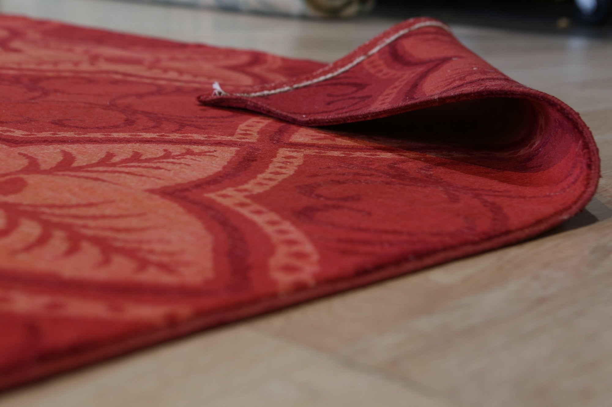 Penelope Maya Red Hand Knotted Afghan Wool Rug, showcasing its vibrant red hues and intricate hand-knotted details, displayed on a light-colored floor in a bright room.