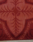 Penelope Maya Red Hand Knotted Afghan Wool Rug, vibrant red hand-knotted wool rug with intricate geometric patterns, displayed on a light wood floor.