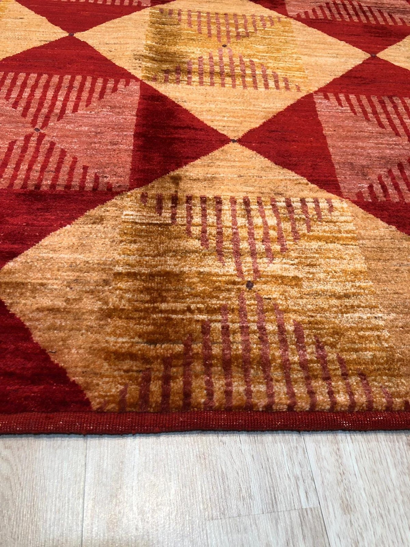 Opulent Classic Red Hand Knotted Afghan Wool Rug, rich red wool rug hand-knotted with intricate classic patterns, filling a sunlit room with warmth and traditional elegance.