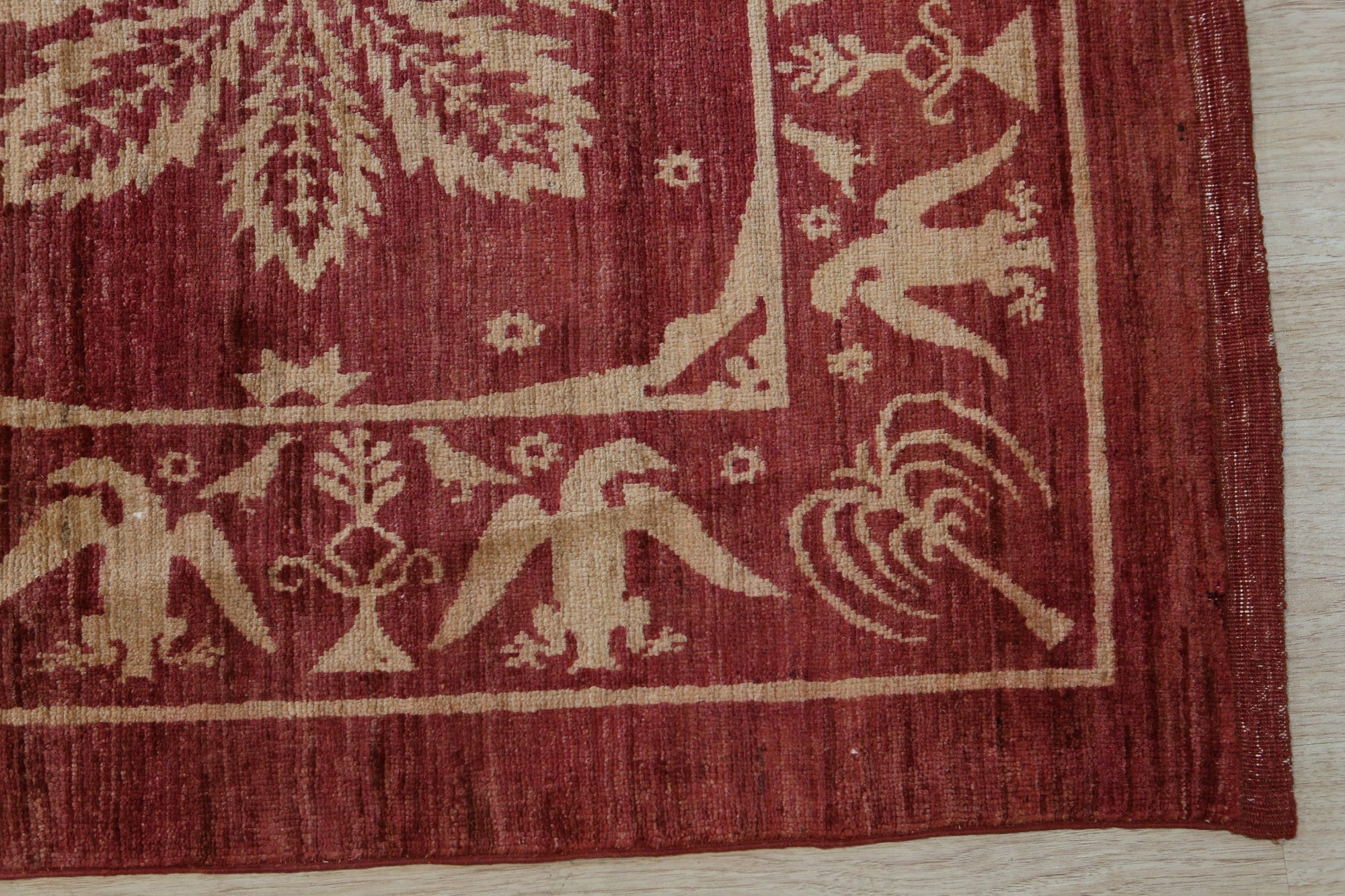 Majestic Artisan Red Hand Knotted Afghan Wool Rug, vibrant red wool covering a living space, showcasing its intricate hand-knotted construction and artisan design.