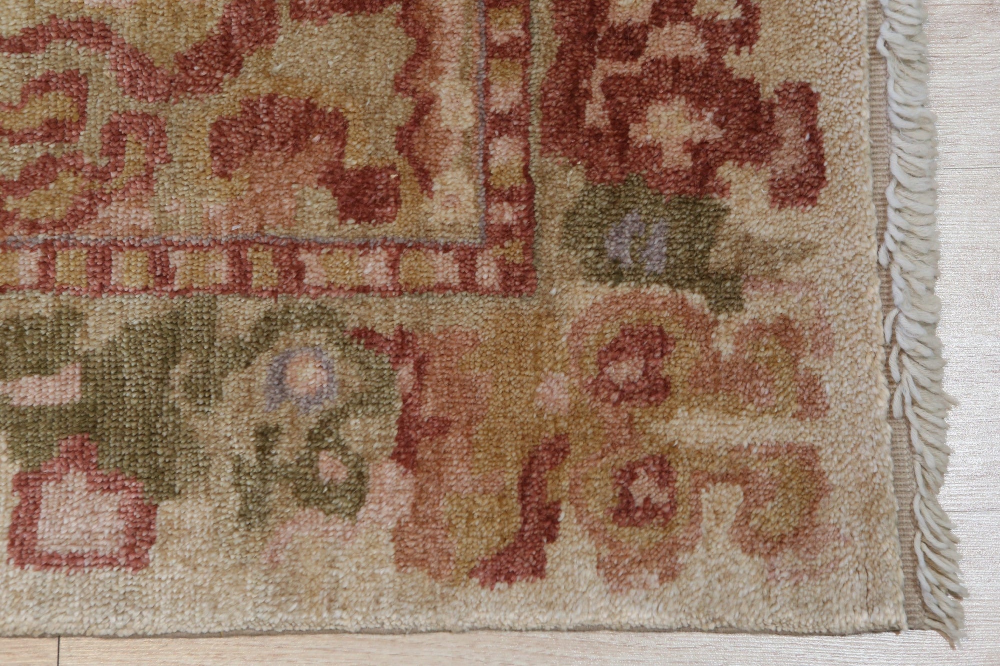 Sarrah Oushak Beige Hand Knotted Rug, showcasing its soft beige tones and intricate, hand-knotted design details in a well-lit room setting.