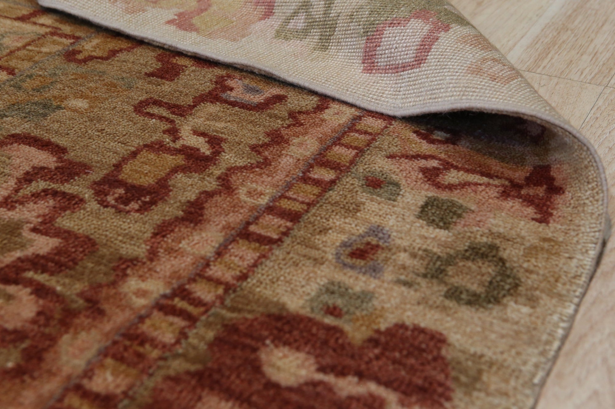 Sarrah Oushak Beige Hand Knotted Rug, a beige and hand-knotted rug with a traditional Oushak design, seen in a bright, neutral room setting.