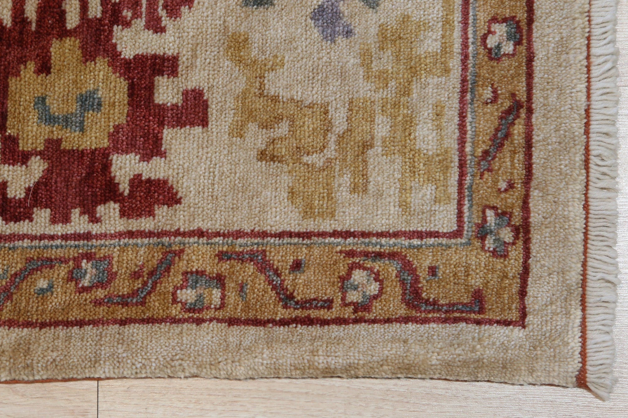 Sarrah Oushak Beige Hand Knotted Rug, a beige wool rug with a traditional Oushak design, seen in a well-lit room setting.