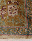 Lush Oushak Green Hand Knotted Rug, its hand-knotted wool pile a soft, verdant expanse, grounding a light-filled living room; subtle, traditional Oushak motifs add understated elegance.