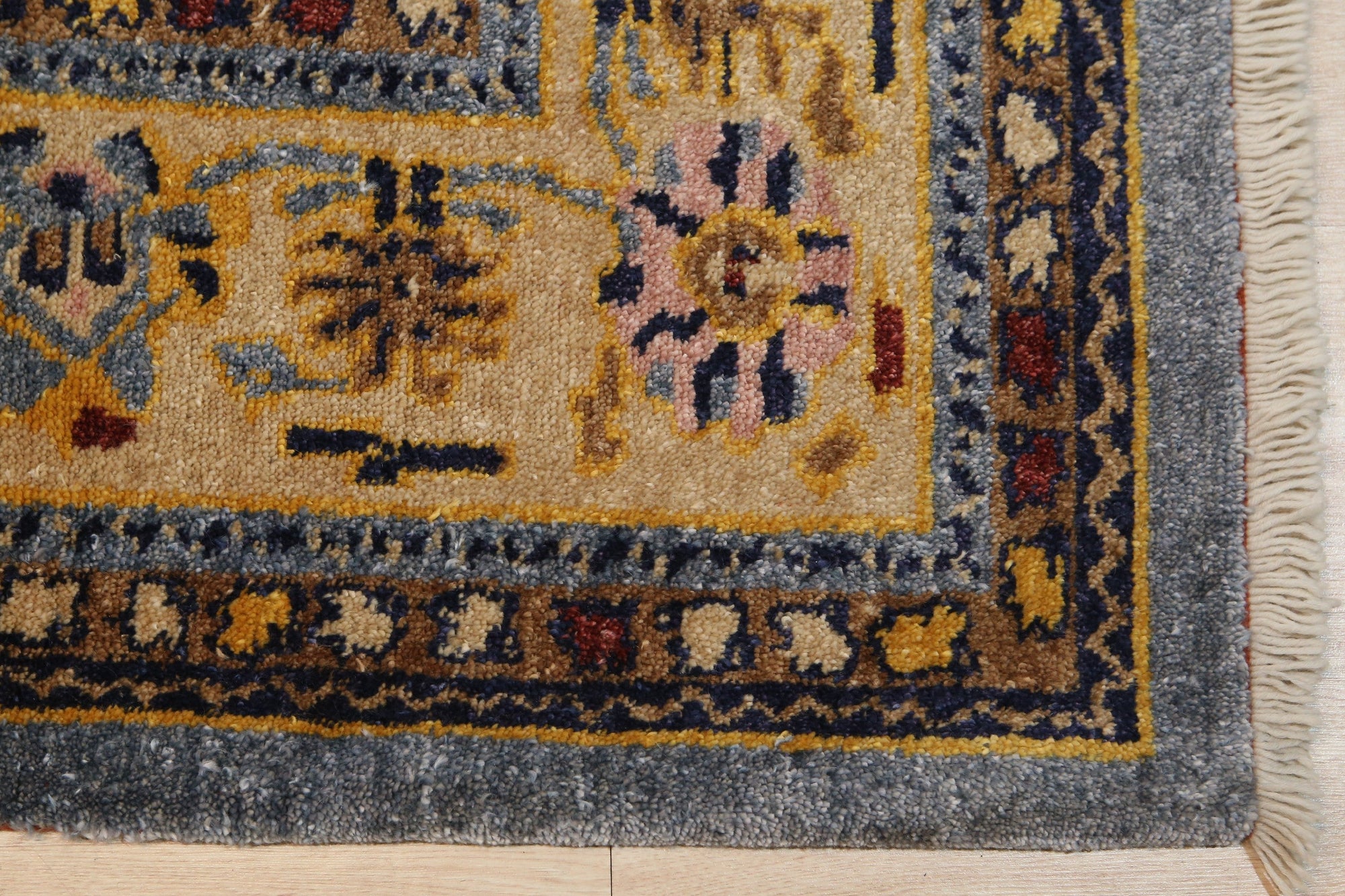 Handcrafted Oushak Blue Hand Knotted Rug, showcasing its intricate floral medallions and subtle abrash variations in soft blues and creams, adding a touch of timeless elegance to a warmly lit room.
