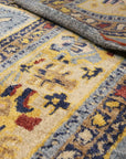 Handcrafted Oushak Blue Hand Knotted Rug, showcasing intricate floral patterns in calming blues and creams, lending an air of timeless elegance to a warmly lit living space.