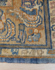 Violet Traditional Blue Hand Knotted Rug, intricate floral patterns dance across a rich blue field, hand-knotted texture adding depth and warmth to a softly lit living space.