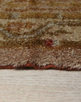 Elena Oushak Beige Hand Knotted Rug, a muted beige rug with a traditional Oushak floral design, seen in a bright living room setting.