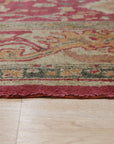 Opulent Oushak Red Hand Knotted Rug, saturated in rich reds and warm neutrals, hand-knotted wool with intricate floral motifs, adding classic elegance to a softly lit room.