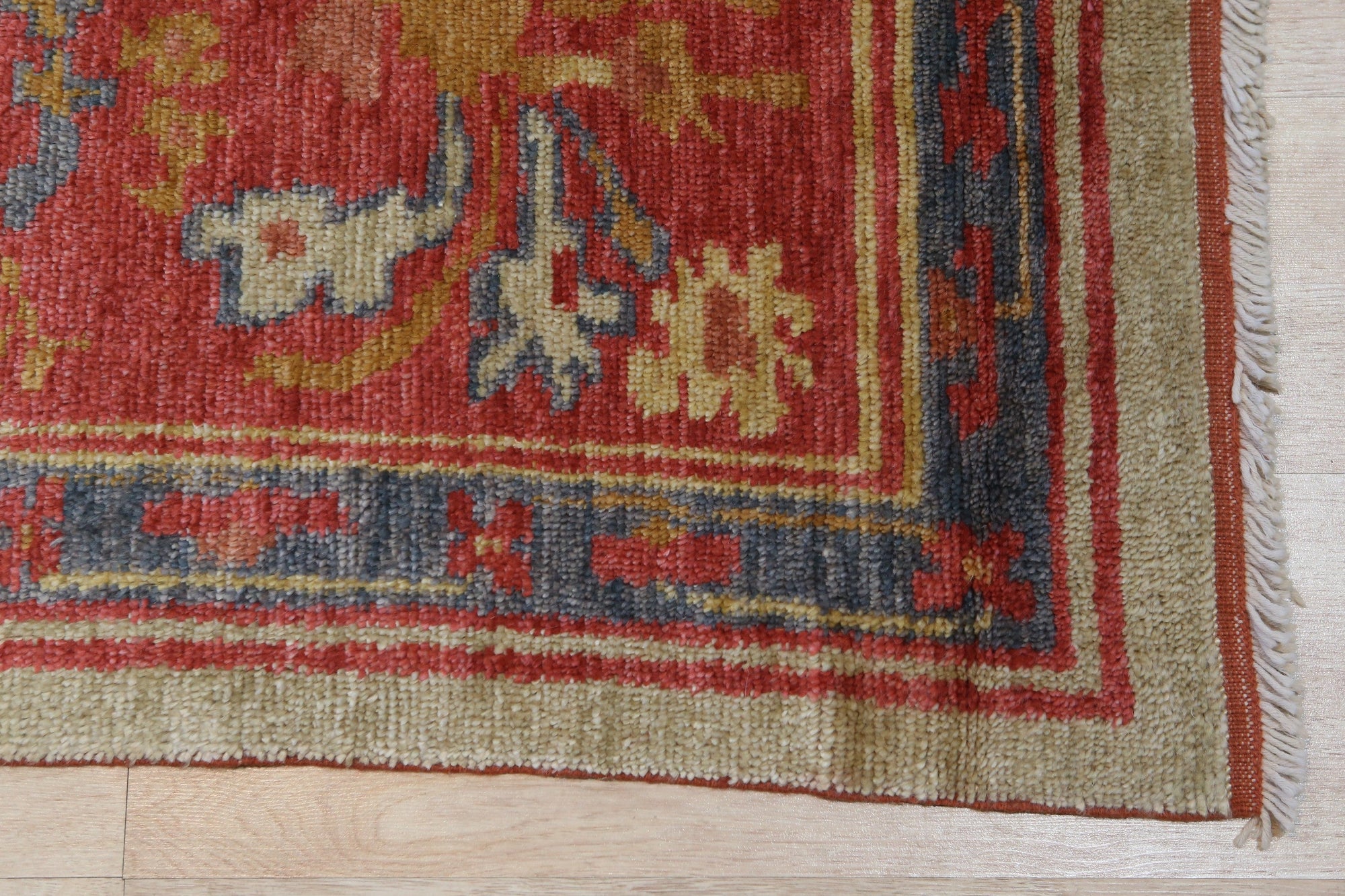 Selene Oushak Red Hand Knotted Rug, vibrant red hues and intricate Oushak patterns enliven a warmly lit interior.