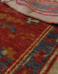 Selene Oushak Red Hand Knotted Rug, its intricate floral patterns and rich red hues warming a softly lit interior.