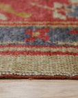 Selene Oushak Red Hand Knotted Rug, a rich red and cream wool rug with an intricate traditional Oushak design, showcased in a living room setting.