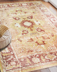 Beautiful Oushak Gold Hand Knotted Rug displayed on a polished hardwood floor, its intricate gold patterns radiating warmth throughout the sunlit room.