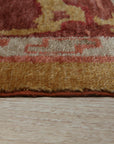 Beautiful Oushak Gold Hand Knotted Rug, its golden hues and hand-knotted construction complement a sun-drenched living room with white walls and light wood floors, adding warmth and texture to the inviting space.