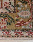 Delicate Oushak Beige Hand Knotted Rug gracing a warmly lit room, its intricate beige patterns and hand-knotted construction lending a touch of understated elegance to the space.