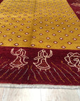 Artisan Quinn Yellow Hand Knotted Wool Rug, bathed in warm sunlight, anchors a bright living space. Its hand-knotted wool construction provides a plush texture underfoot, while subtle variations in yellow hues create a sophisticated, inviting atmosphere within the room.