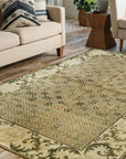Classic Elena Green Hand Knotted Wool Rug, a lush emerald and ivory wool rug with a traditional, ornate pattern, displayed in a bright, modern living room setting.