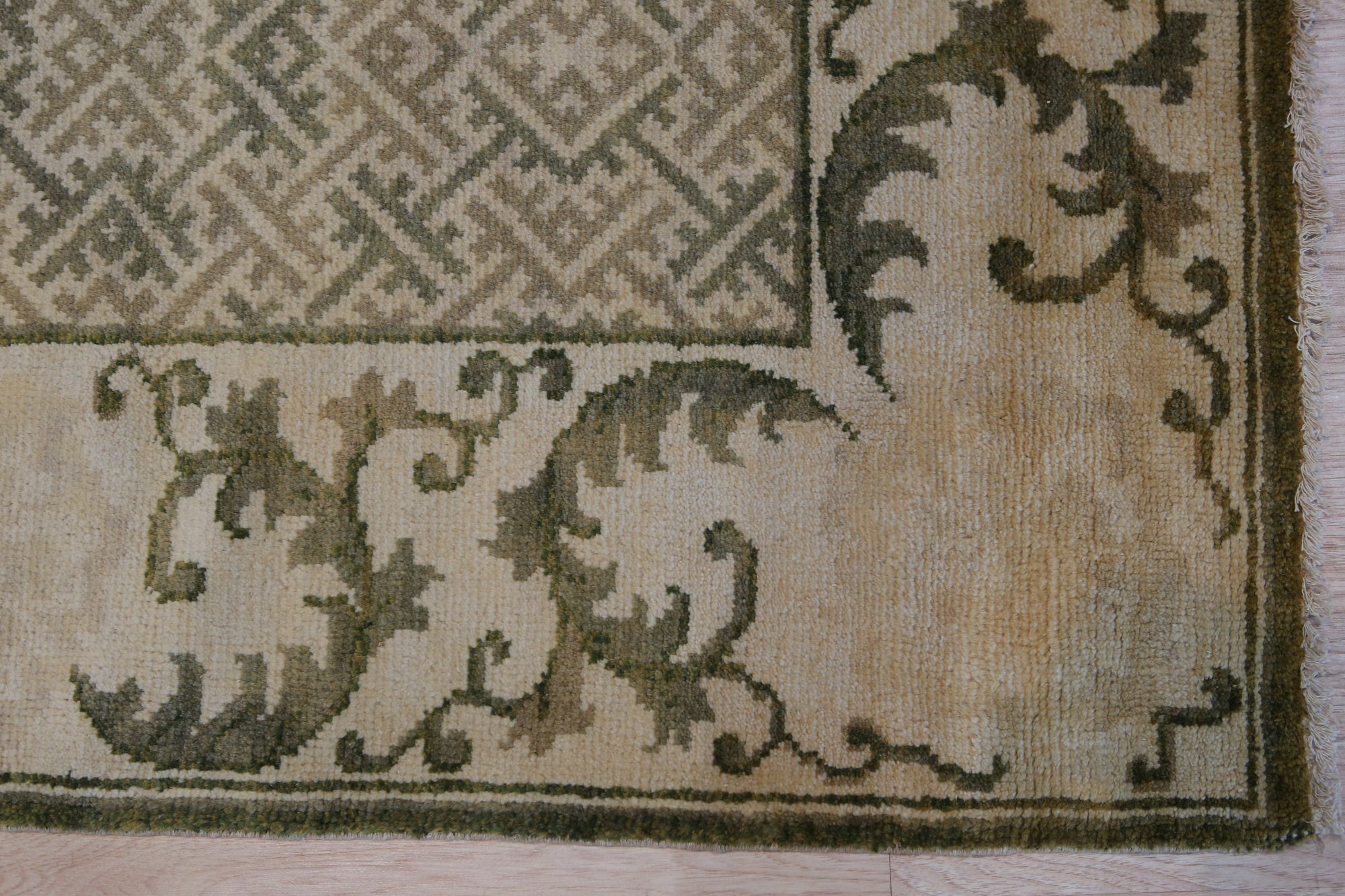 Classic Elena Green Hand Knotted Wool Rug, lush green wool rug with a traditional, intricate pattern, draped beautifully, suggesting a sense of luxury and warmth.