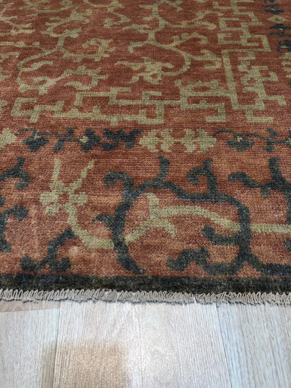 Lydia Jasmine Red Hand Knotted Wool Rug, vibrant reds and subtle creams interweave in a hand-knotted wool texture, showcasing intricate floral designs.