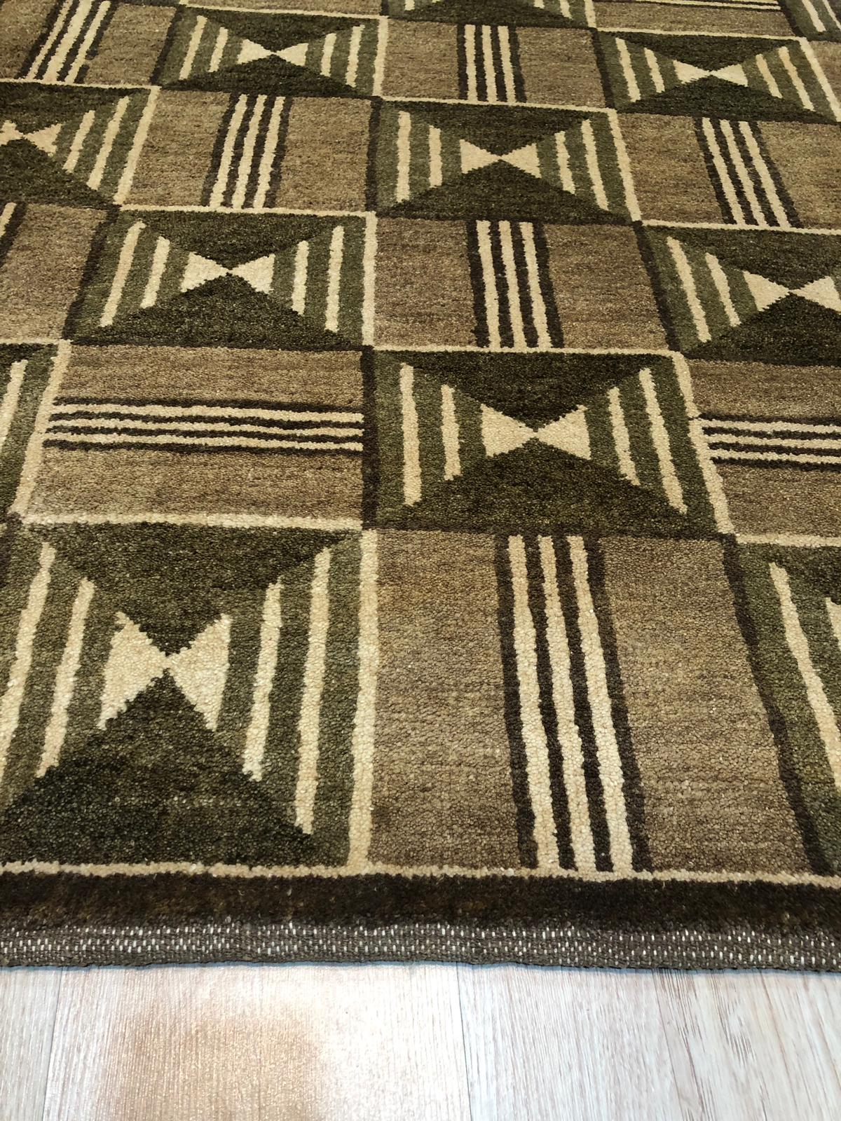 Sumptuous Giselle Brown Hand Knotted Wool Rug, showcasing a rich brown palette and intricate hand-knotted construction, nestled within a warmly lit interior space.